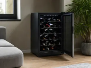 Compact modern electric wine cellar in a stylish apartment, open to show neatly organized wine bottles and an energy rating label, with soft daylight and minimalist decor.